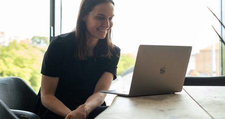 woman working with laptop and sitting at the desk