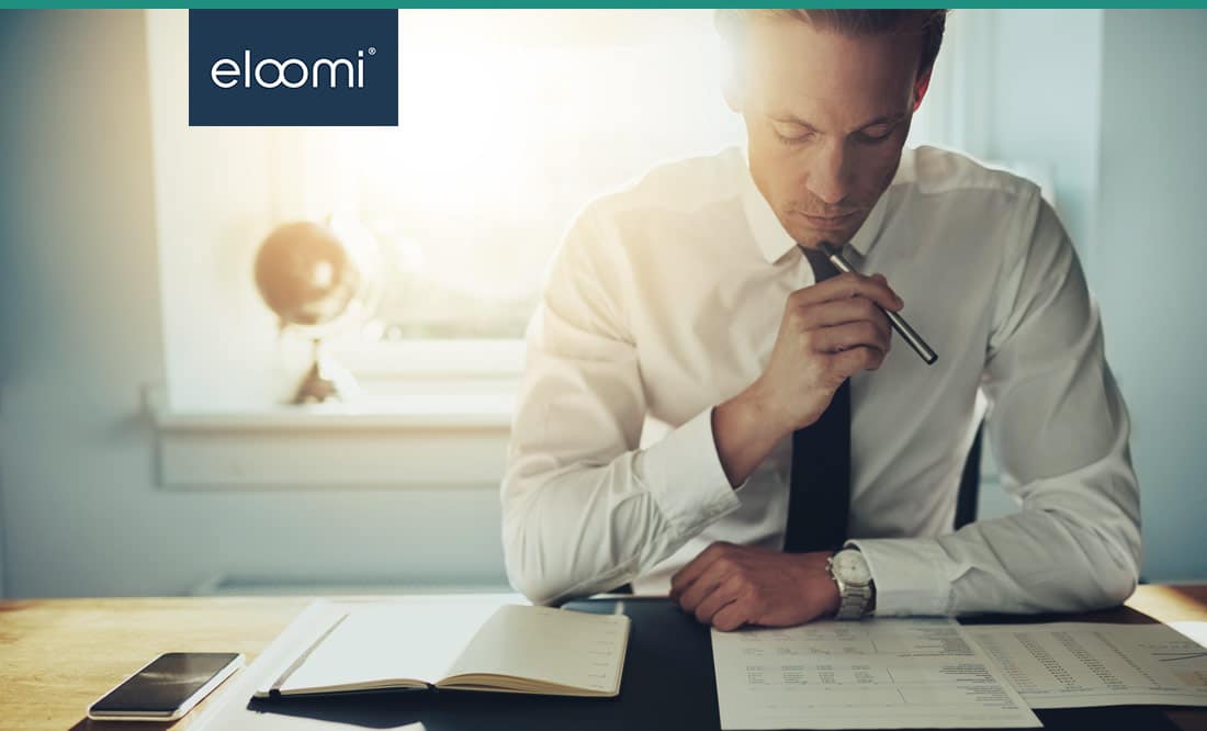 Man at his desk analysing employee performance data