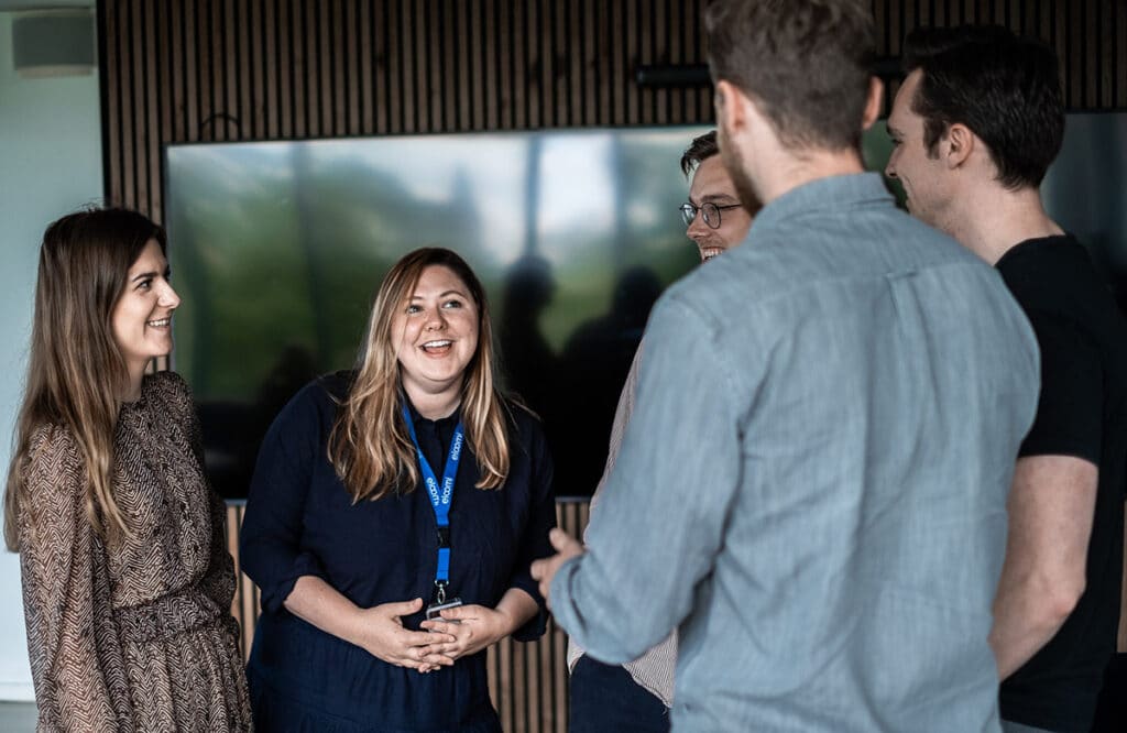 employees talking and smiling together