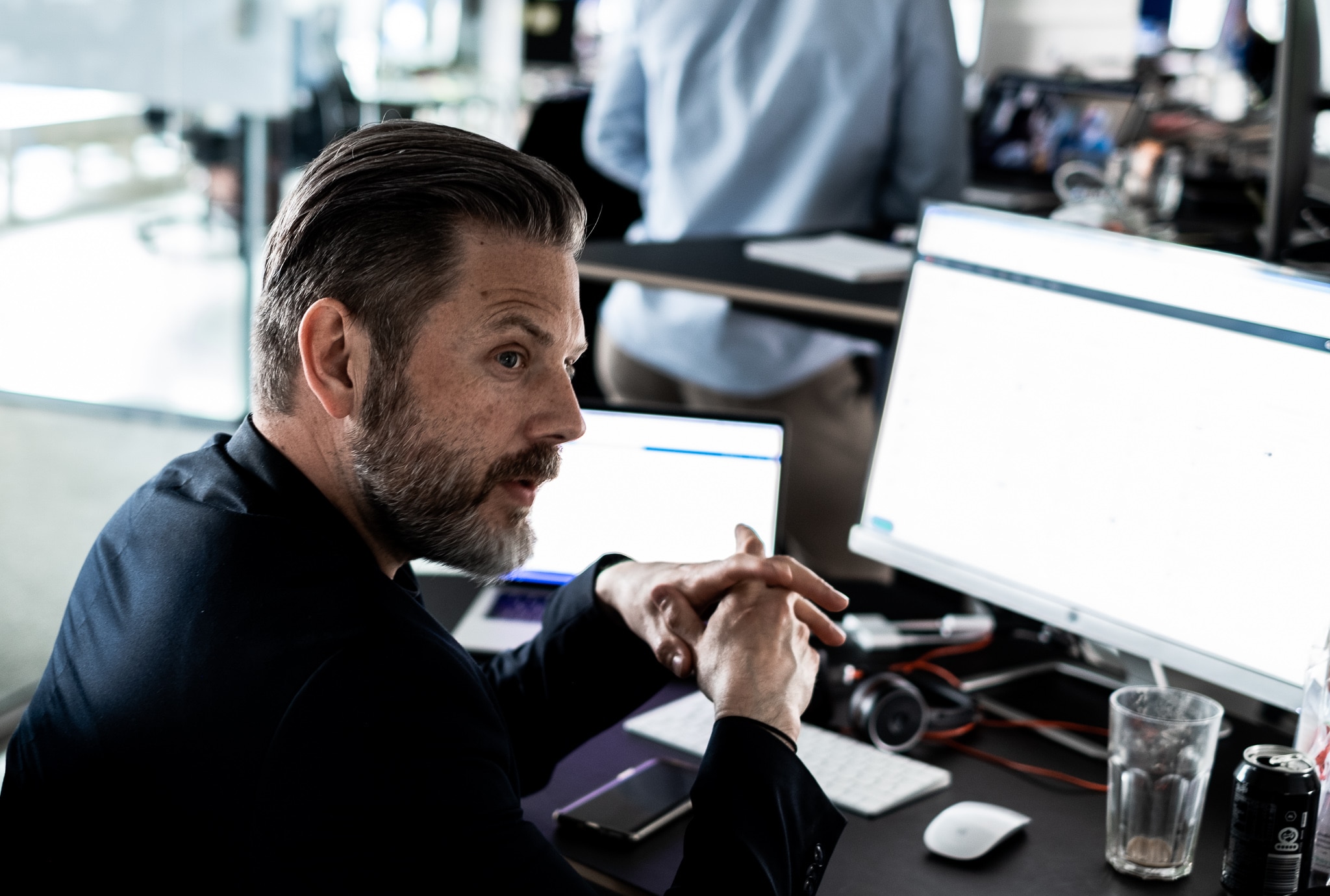 male employee working in front of a screen in an open office space
